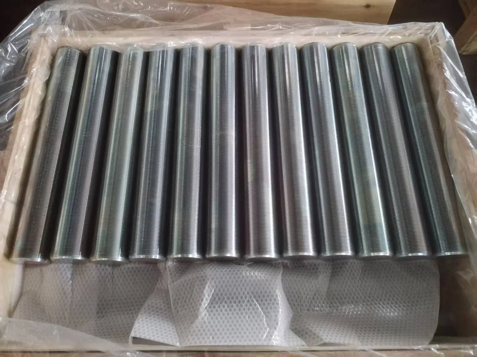 Full-thread B7 studs arranged in a lined wooden case before dispatch