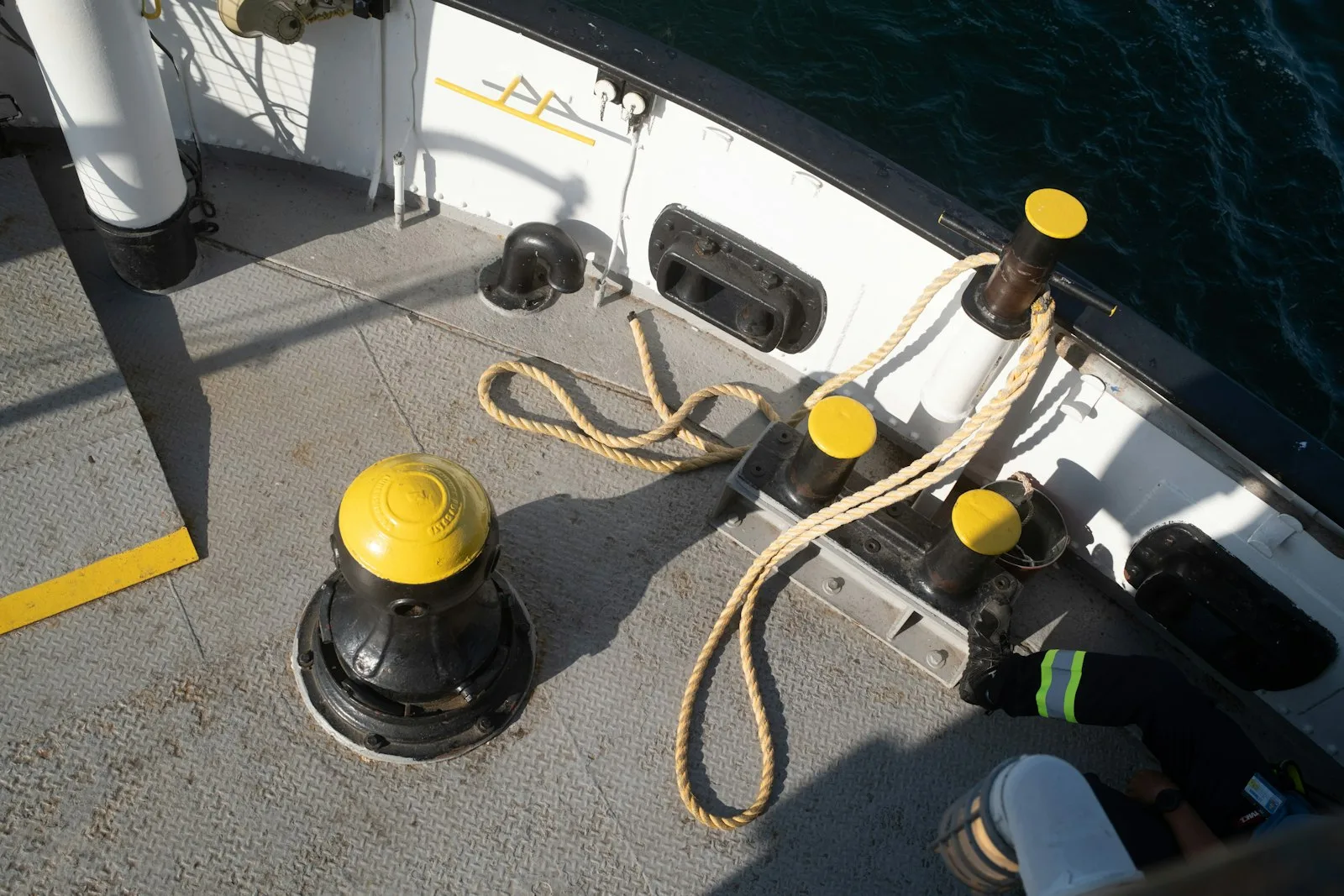 Commercial ship weather deck with bollards, capstan, bulwark rail and bolted equipment bases