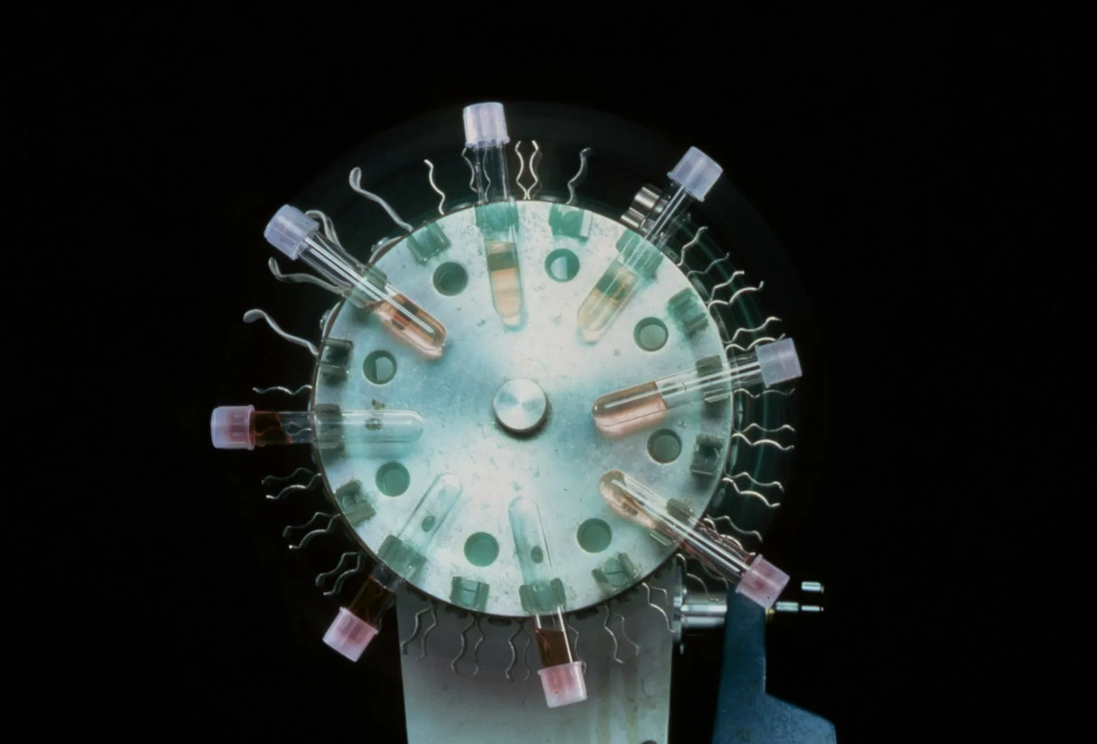 Laboratory centrifuge rotor and instrument housing with visible assembly screws and clamp fasteners