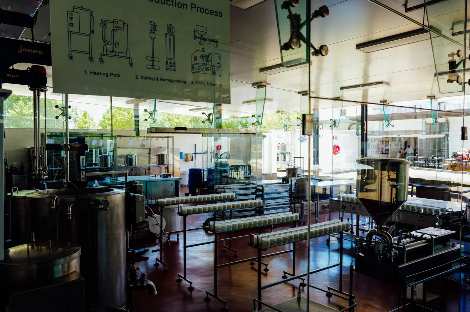 Stainless food-production line with bolted conveyor frames, glass-guard spider fittings and equipment supports