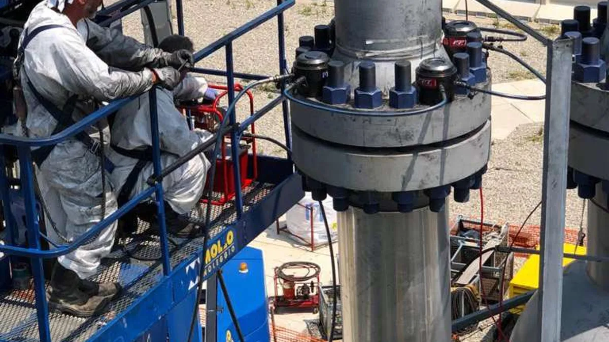 Refinery turnaround maintenance crew working on critical flange joints