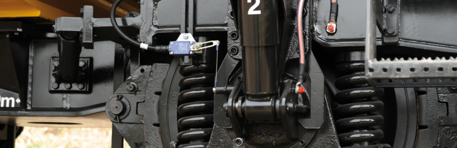 Close-up of railway bogie suspension and bolted running gear